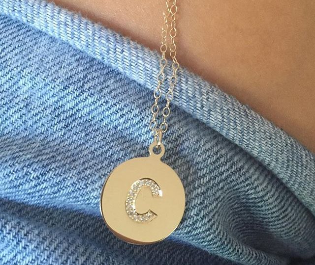 Our initial disc necklace in yellow gold with diamonds makes the PERFECT holiday gift for someone special  #alexisjewelry #finejewelry #holidayshopping #giftgiving #stockingstuffers #giftideas #madeinla #losangeles #yellowgold #diamonds #necklace #initials